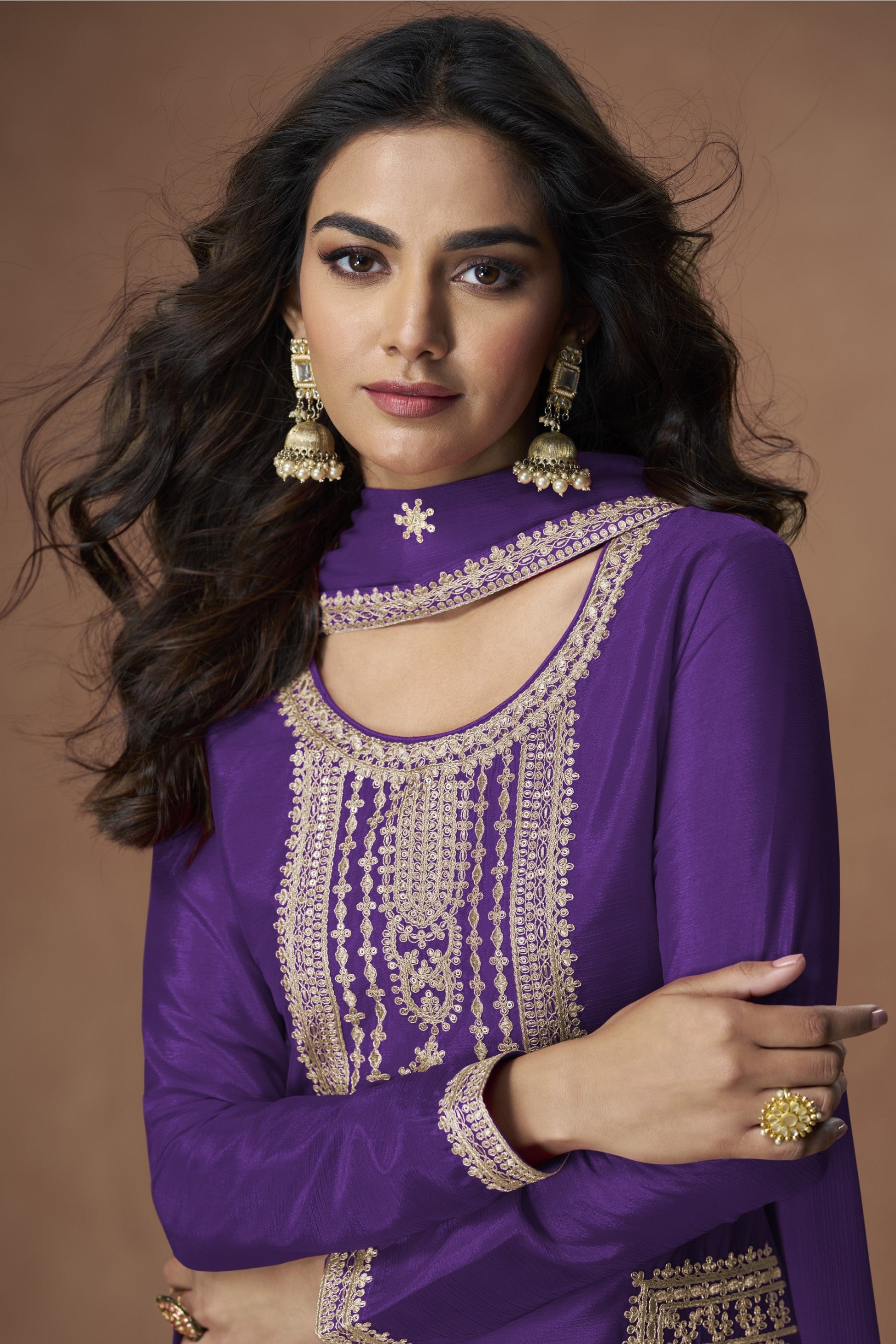 Purple color palazzo suit with embroidery work, offering a regal and graceful look ideal for festive and traditional occasions.
