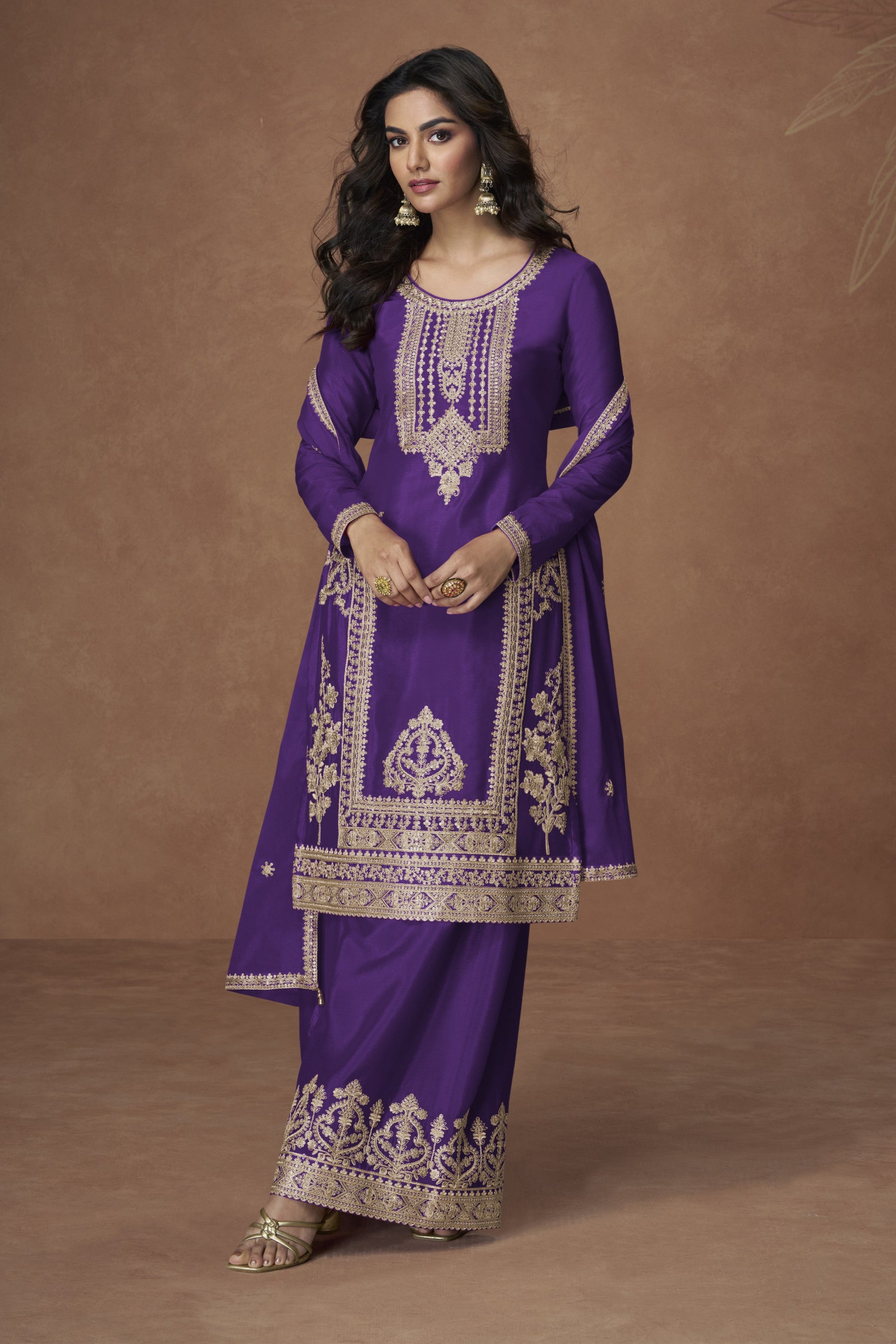 Purple color palazzo suit with embroidery work, offering a regal and graceful look ideal for festive and traditional occasions.
