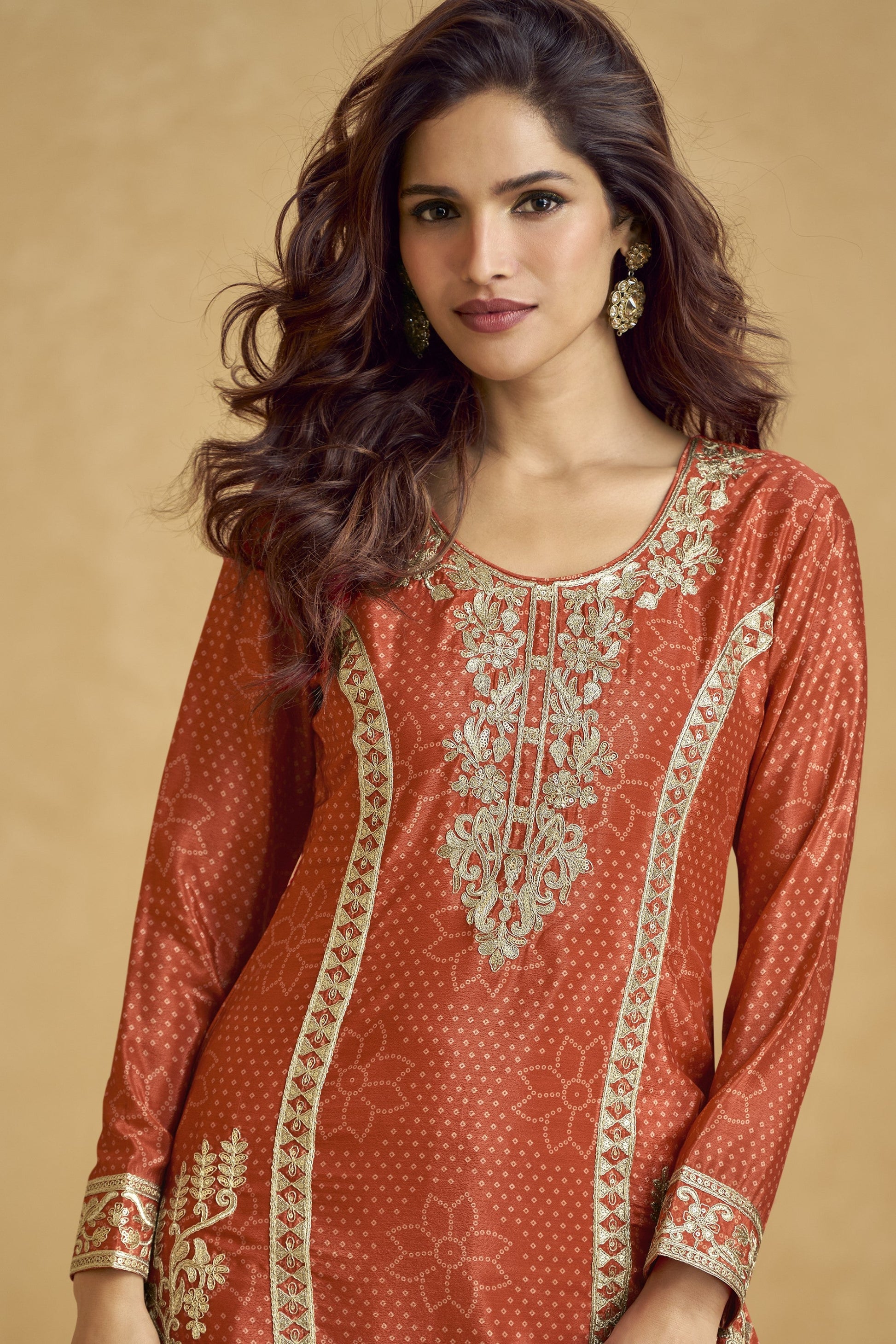 Rich dark orange outfit with bold traditional charm, ideal for festive functions, mehndi nights, and cultural celebrations.
