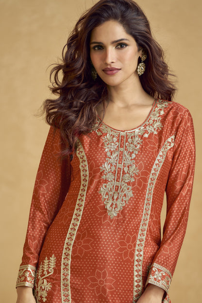 Rich dark orange outfit with bold traditional charm, ideal for festive functions, mehndi nights, and cultural celebrations.
