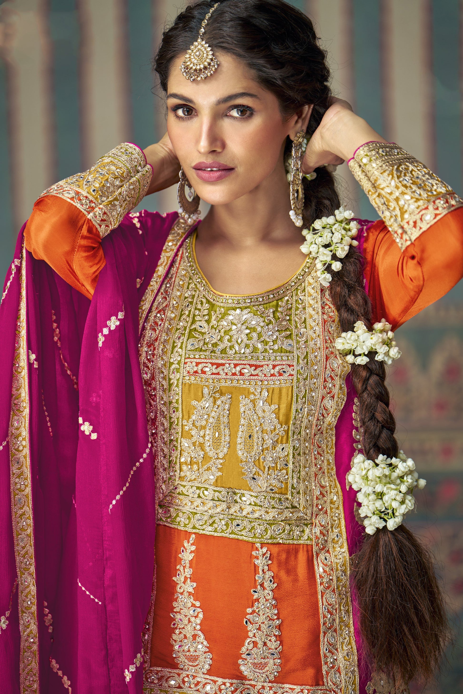 Orange color palazzo suit in Chinon silk fabric with embroidery work, radiating festive vibrance and graceful charm for special celebrations.
