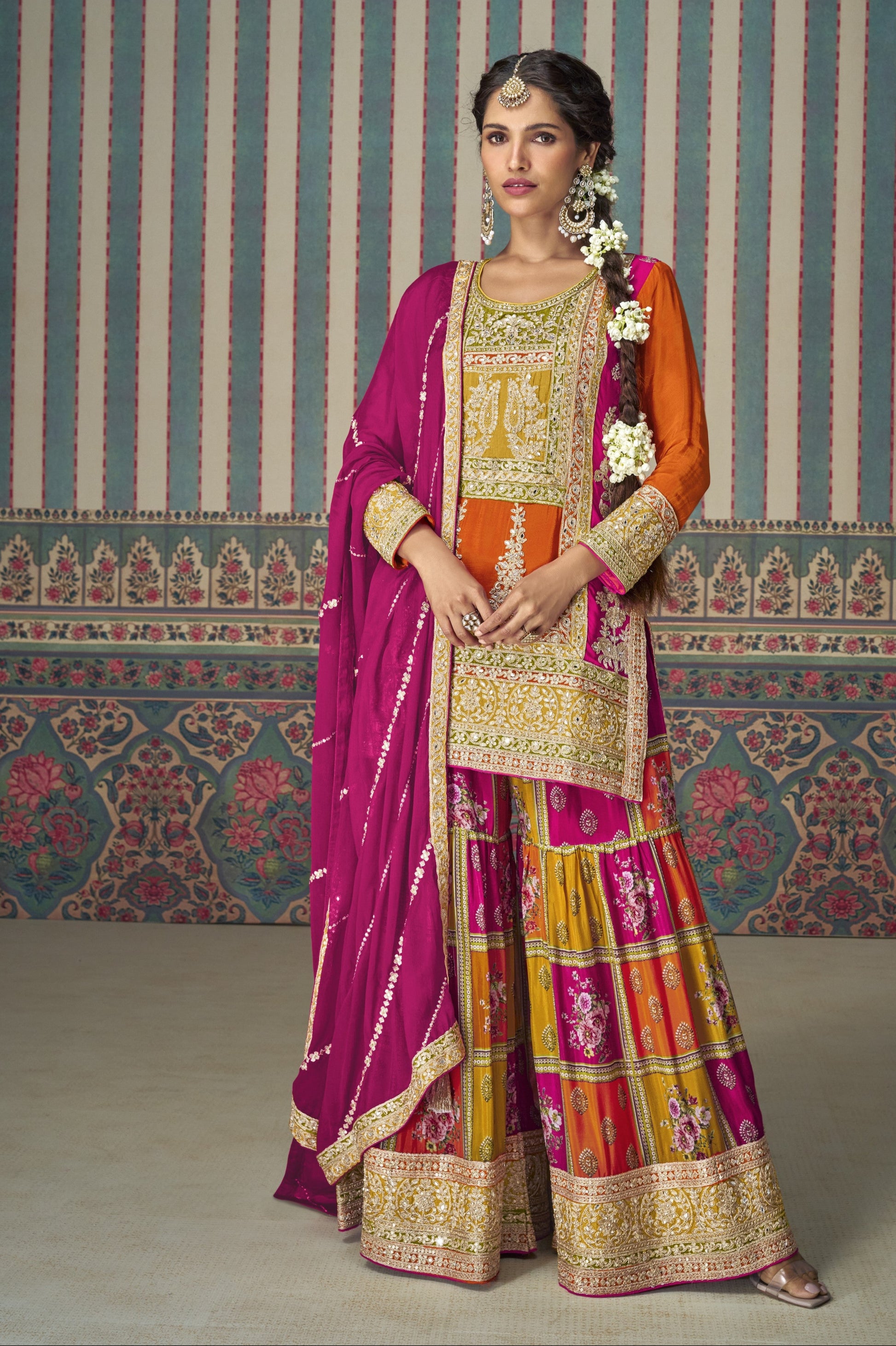 Orange color palazzo suit in Chinon silk fabric with embroidery work, radiating festive vibrance and graceful charm for special celebrations.
