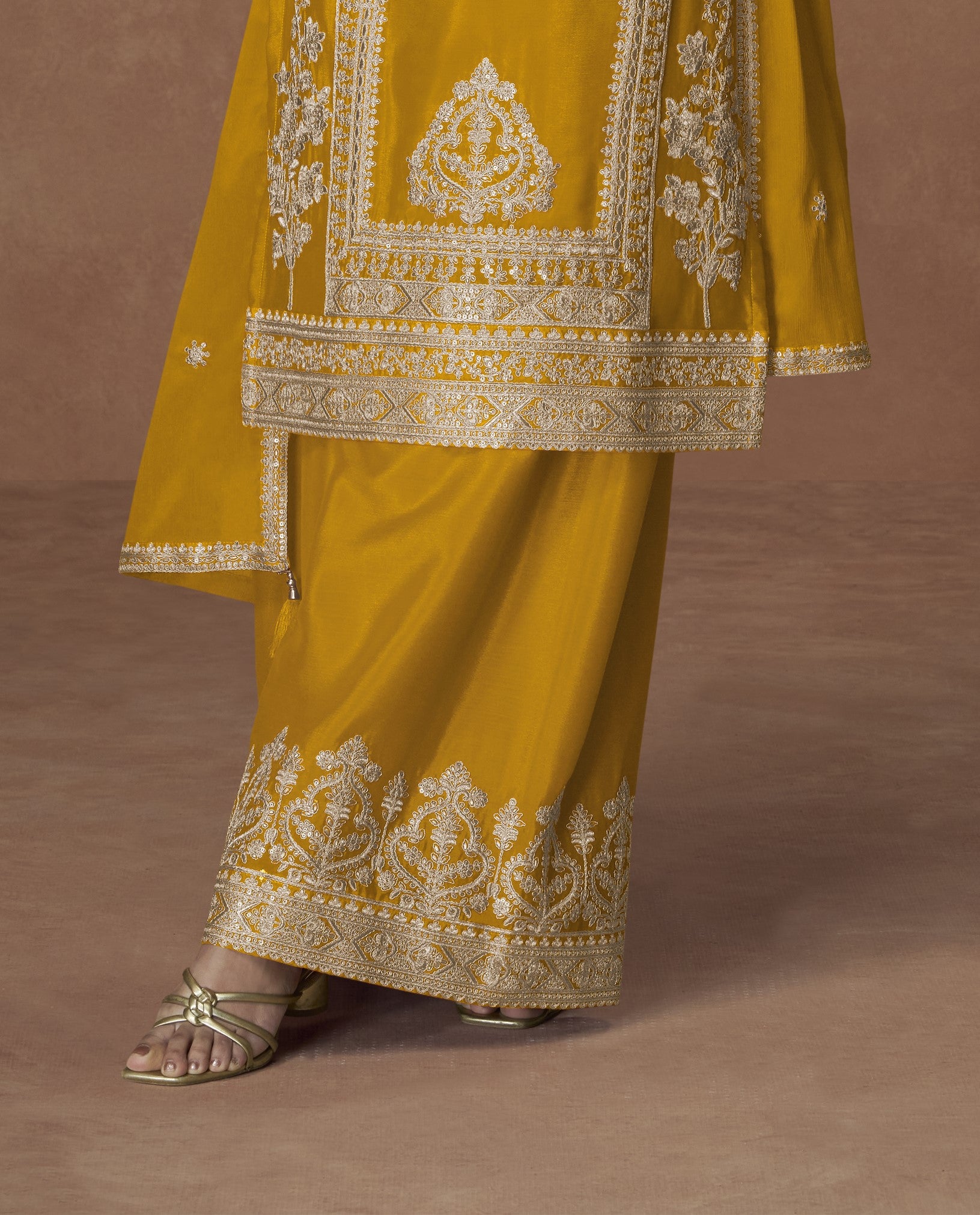 Yellow color palazzo suit with embroidery work, radiating bright and joyful elegance perfect for festive and cultural celebrations.
