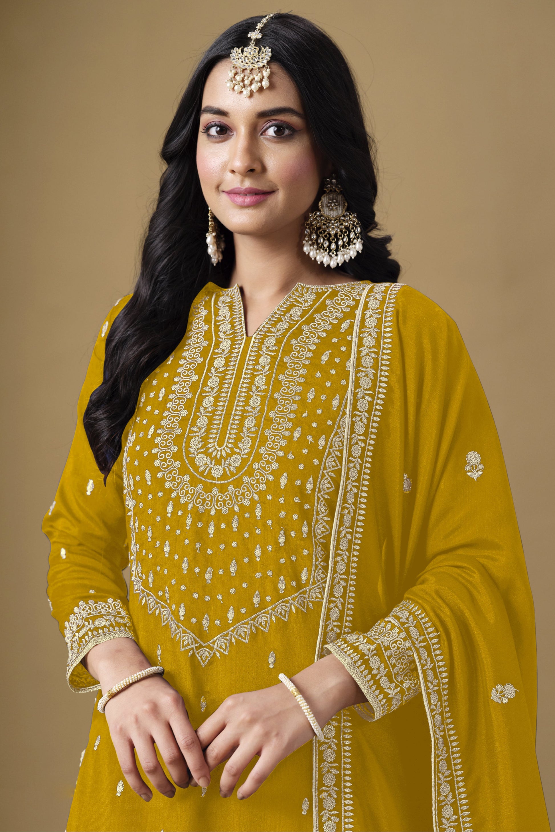 Yellow salwar kameez is bright and happy. Good for haldi or sunny events.
