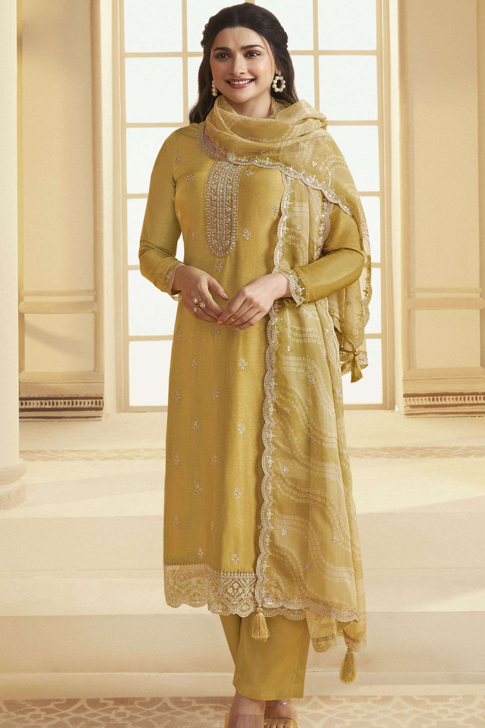 Yellow salwar kameez is bright and happy. Good for haldi or sunny events.
