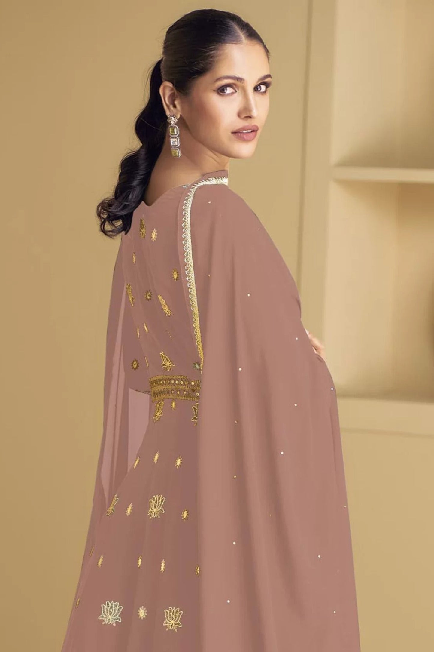A Woman Modeling Peach Anarkali Gown With Embroidery Work