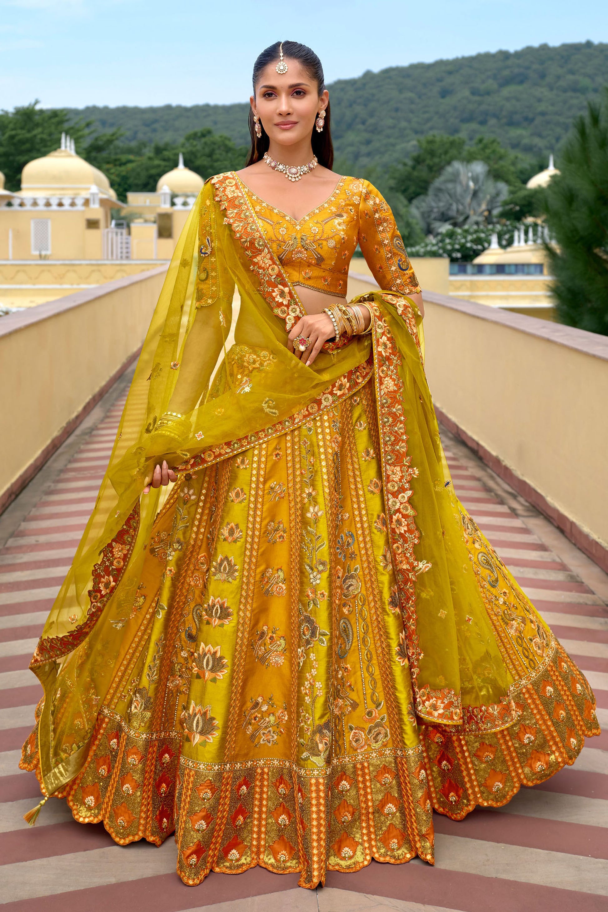 Yellow silk wedding lehenga choli with sequin embroidery and mirror work for Indian bridal ceremonies