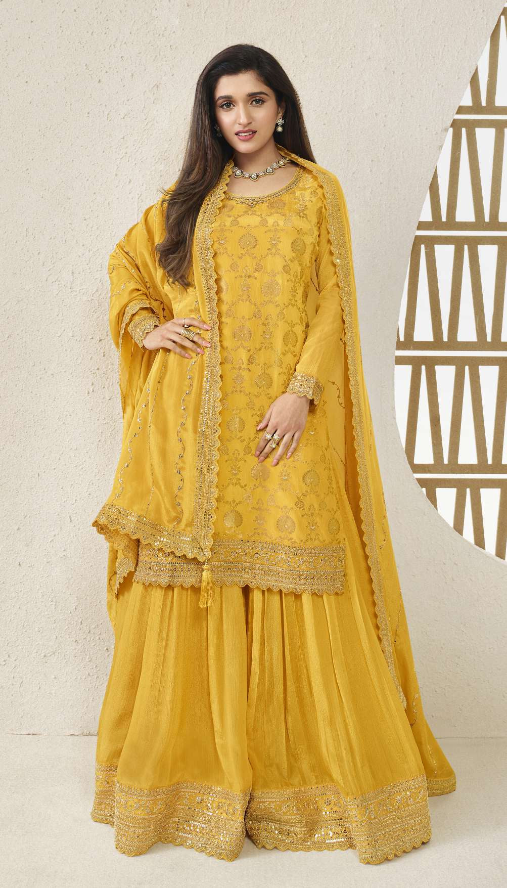 A Woman Wearing  Yellow Indian Salwar Kameez Palazzo Dupatta Dress with Embroidery Work