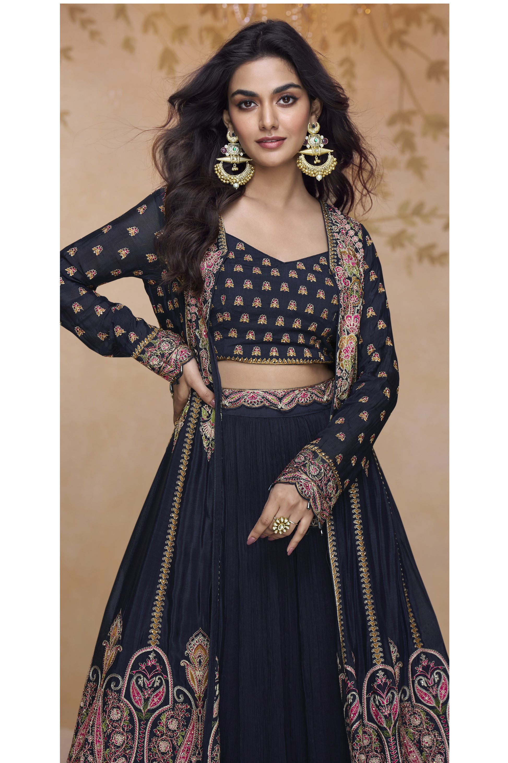Close-up of black designer Anarkali gown with ornate embroidery, matching crop top, and full-length embellished jacket
