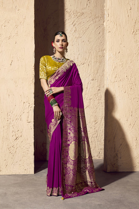 Woman wearing a mergenta pink saree with gold patterns 