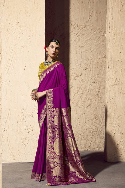 Woman wearing a pink saree with gold patterns with a side view
