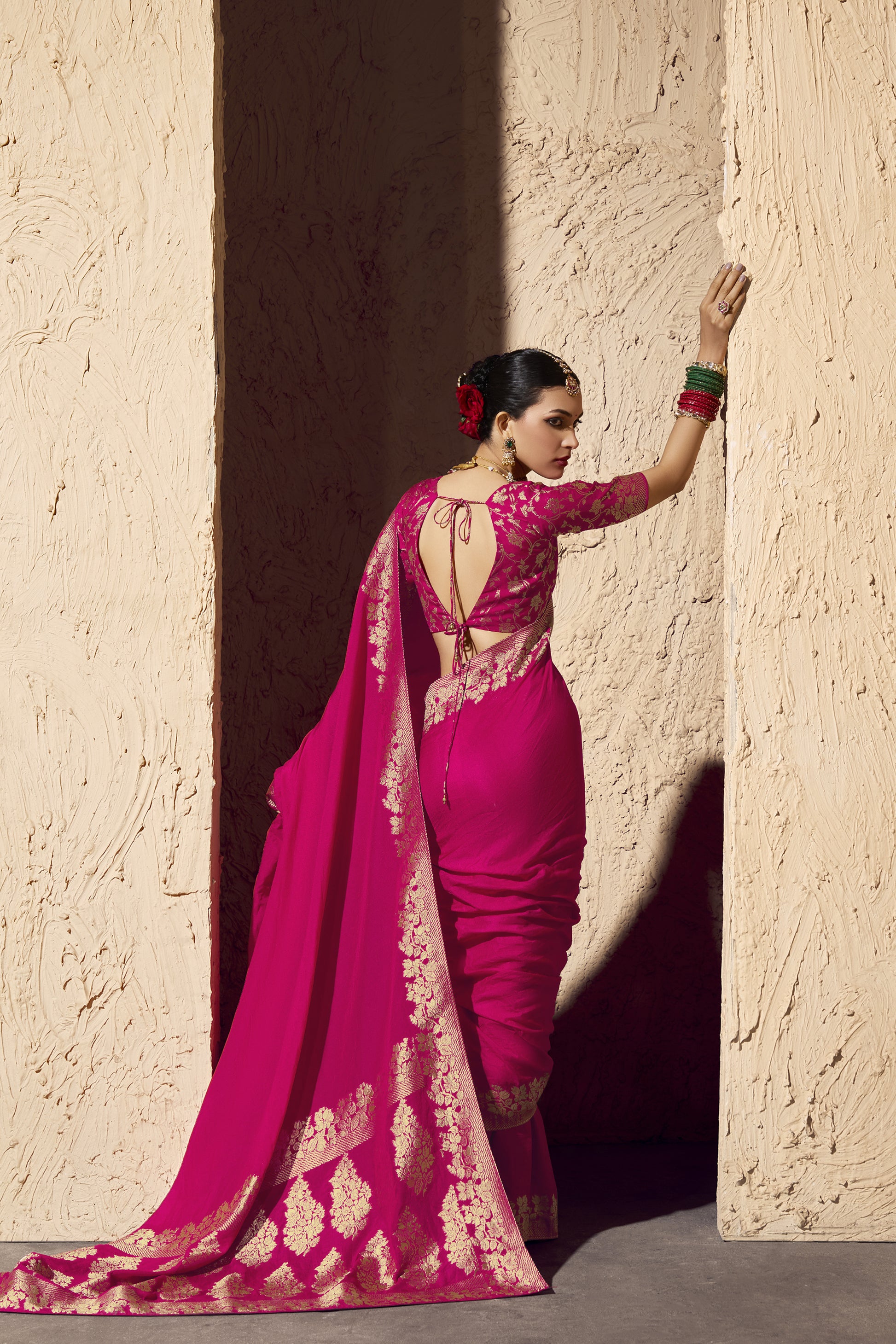 Modern Bollywood style pink saree drape with heavy gold border work, Luxury Indian party wear saree available online at Seyuri.