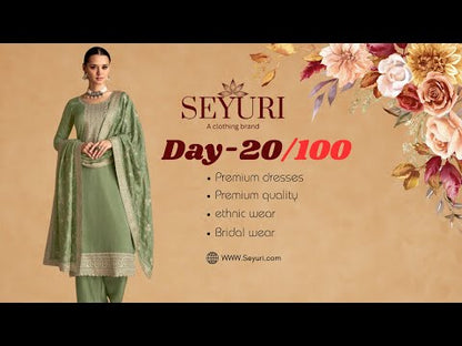 Elegant silk salwar suit featuring cyan blue chinon fabric and detailed embroidery design.