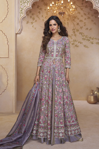 Model dressed in a pastel lilac embroidered Anarkali gown featuring multicolor threadwork and a flowing silk dupatta.
