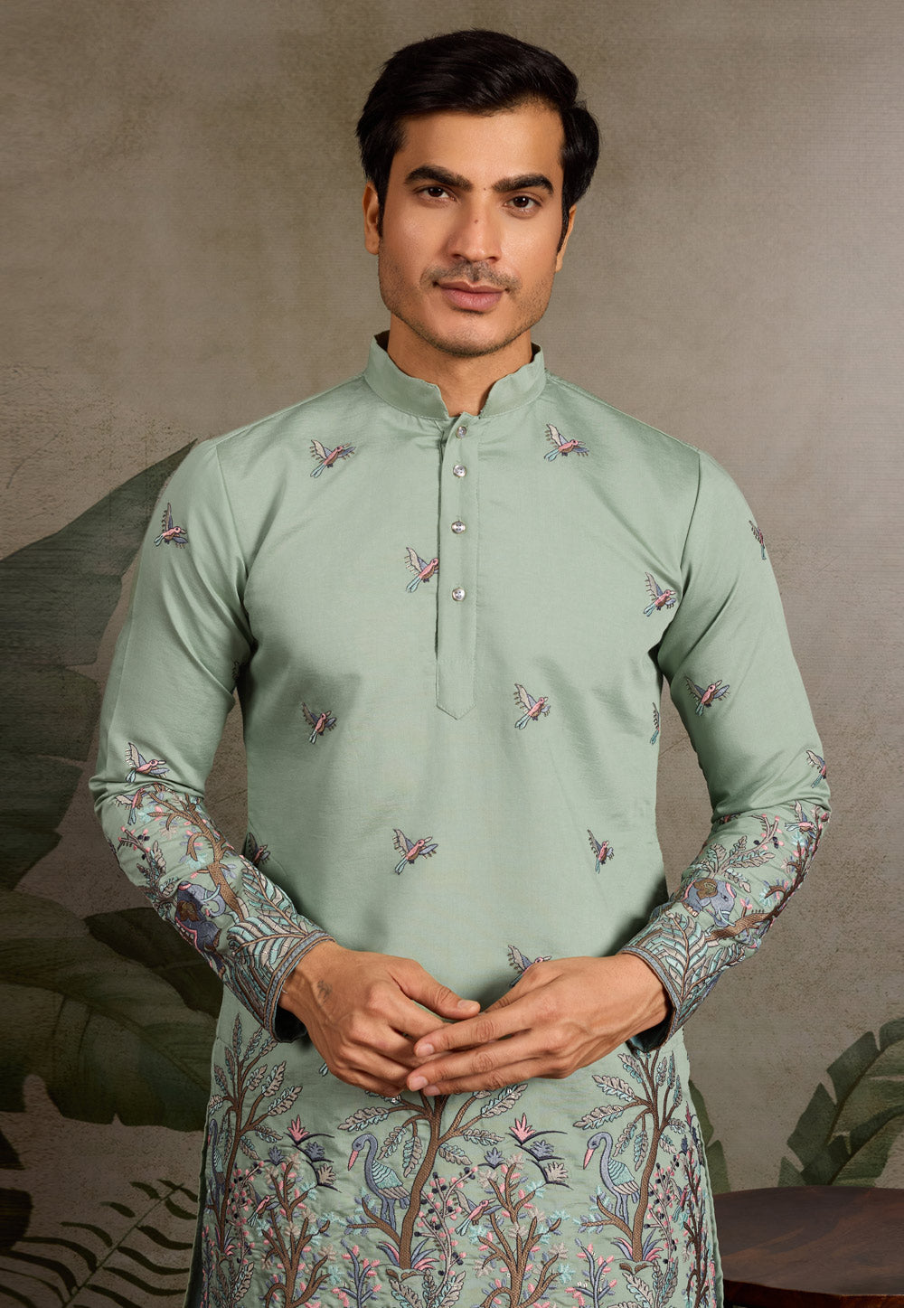 sage green kurta set detailed embroidery close up
