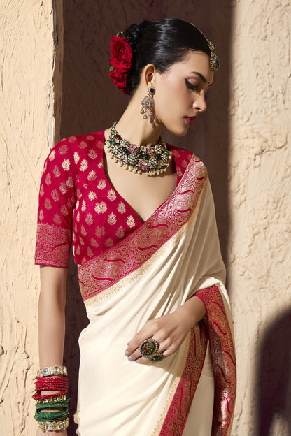 Traditional Indian silk saree in red and white with rich gold detailing, perfect for weddings.
