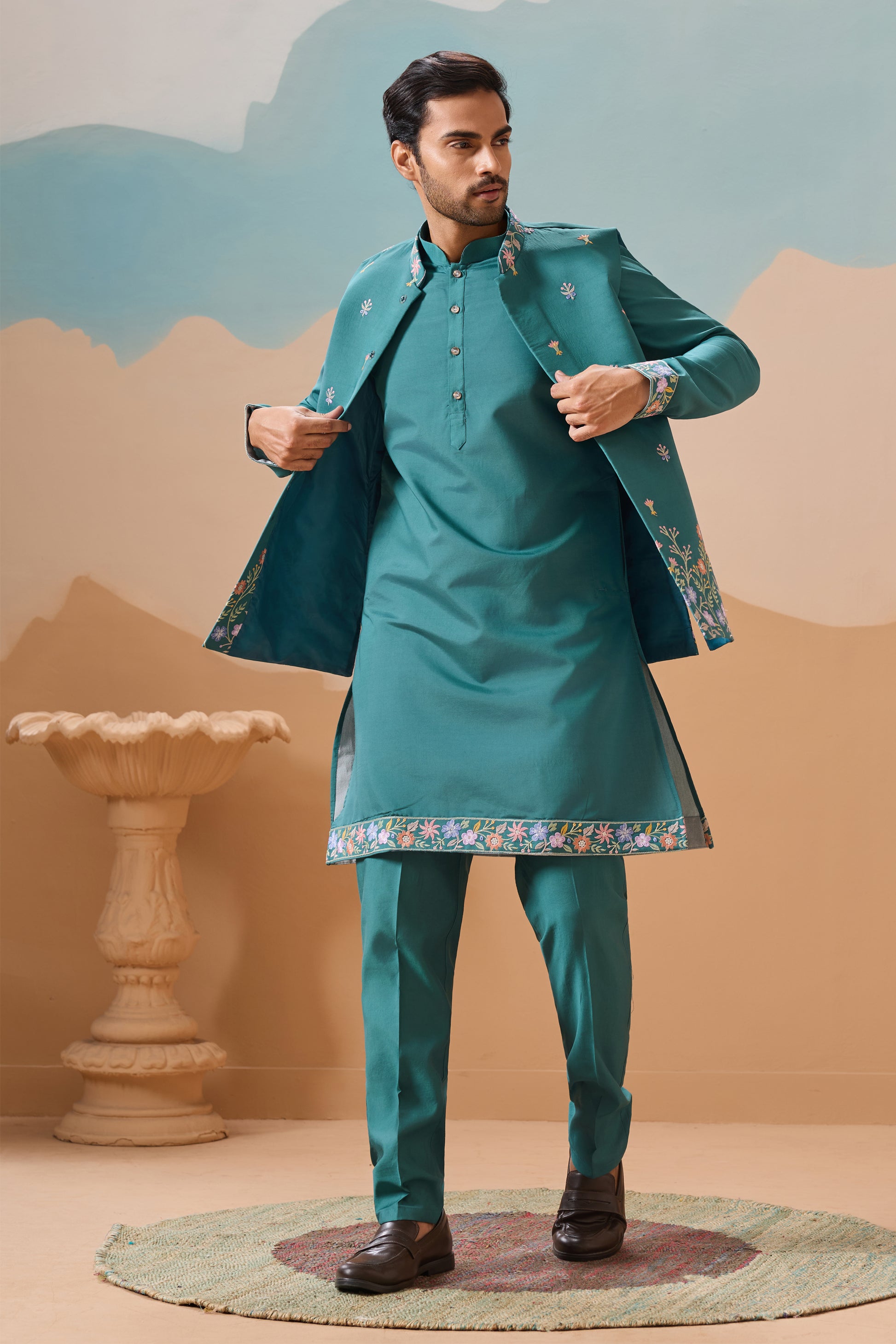 Teal kurta with koti styled for wedding occasion
